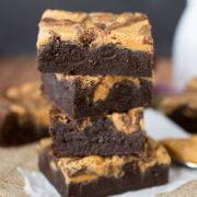 Stack of Peanut Butter Swirl Brownies on parchment paper
