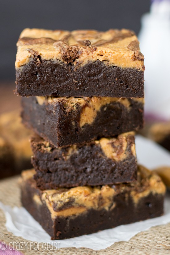 Stack of Peanut Butter Swirl Brownies on parchment paper
