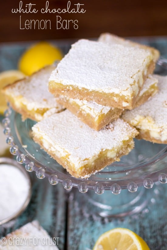 White Chocolate Lemon Bars on glass cake pedestal with title