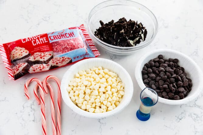 ingredients in bark - chocolate chips and candy canes and Oreos in bowls