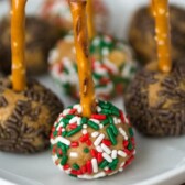Peanut Butter Cheeseball Pops on a white plate with title