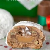 Rolo Stuffed Chocolate Snowballs sliced in half on holiday paper with title