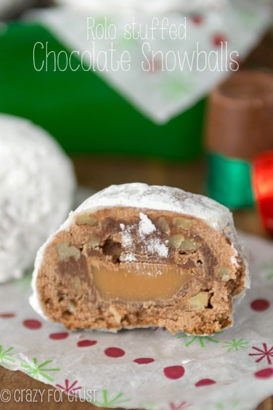 Rolo Stuffed Chocolate Snowballs sliced in half on holiday paper with title