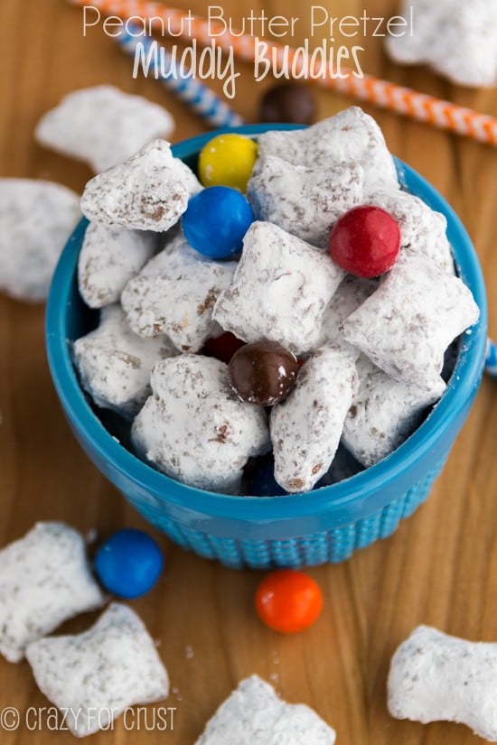 muddy buddies made with peanut butter pretzels and M&Ms in a blue dish