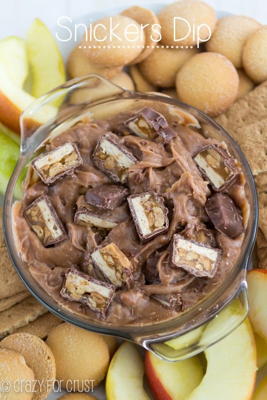 Overhead shot of snicker dip with apples and cookies and title