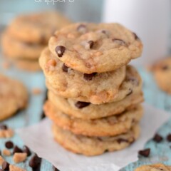 Stack of toffee chocolate chippers on parchment paper with title