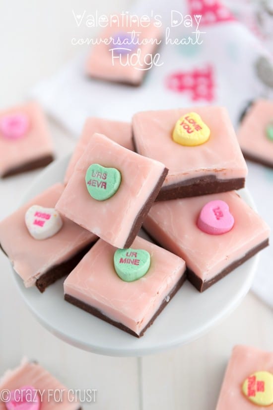 stack of valentine fudge with chocolate and pink layer and conversation hearts on white plate
