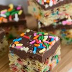 funfetti cookie bars with fudge topping and sprinkles