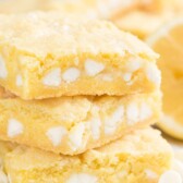 Lemon gooey bar stack on parchment paper with title