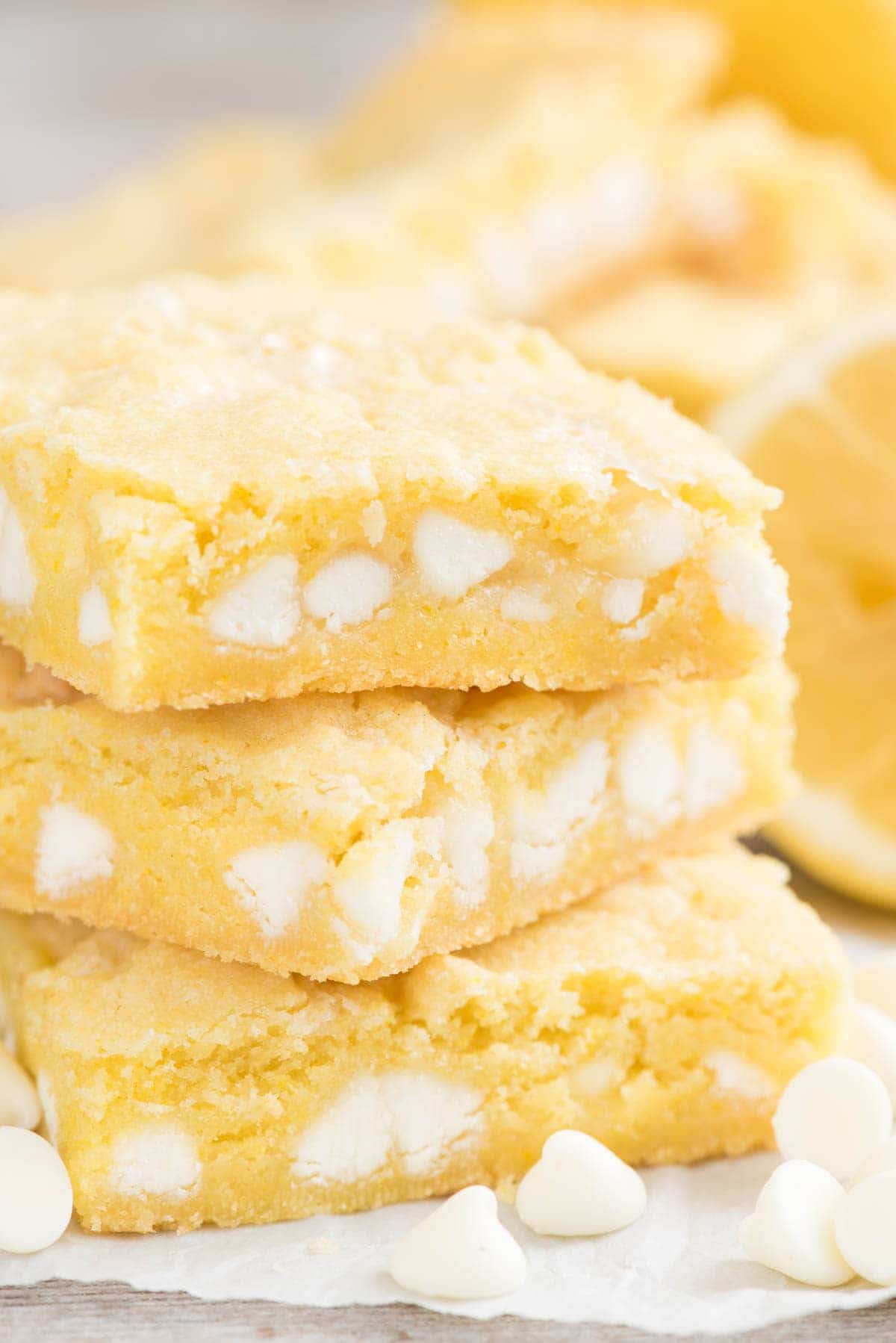 Lemon gooey bar stack on parchment paper with title