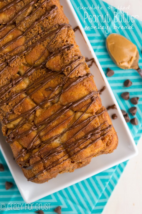 Peanut Butter Monkey Bread Loaf sitting on white plate on teal towel