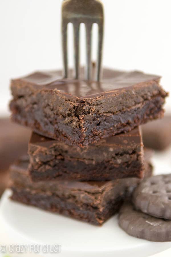 Stack of Thin Mint Truffle Brownies with a fork stuck in the top brownie