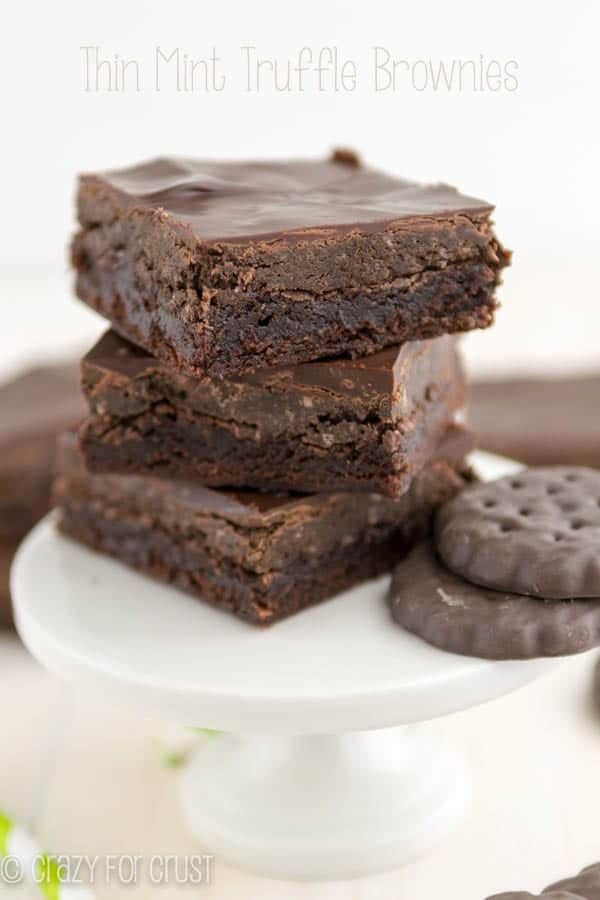 brownies with thin mint truffle topping on white stand in a stack
