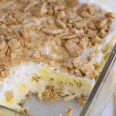 no bake lemon dessert in glass pan with slice missing