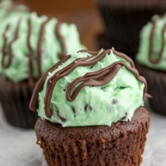 brownie cupcake with mint frosting and chocolate drizzle