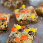 sliced oatmeal cookie bars with reese's on top on rustic wood surface