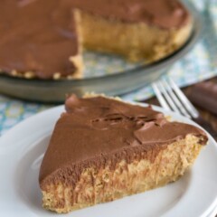 slice of peanut butter pie with chocolate top on white plate