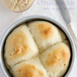 overhead shot of 4 dinner rolls in small cake pan