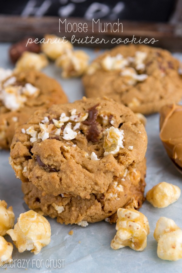 Moose Munch Peanut Butter Cookies on parchment paper with ingredients scattered around and recipe title at top of photo