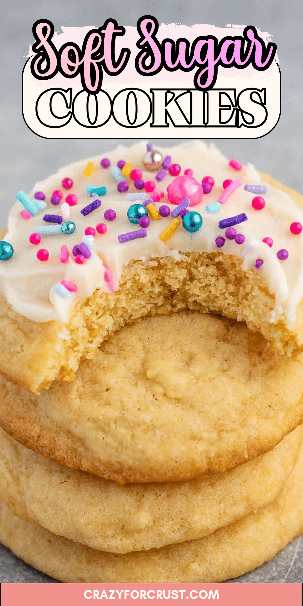 A stack of soft sugar cookies, the top one frosted with white icing and colorful sprinkles, has a bite taken out of it. The image features the text Perfect Sugar Cookies and crazyforcrust.com at the bottom.