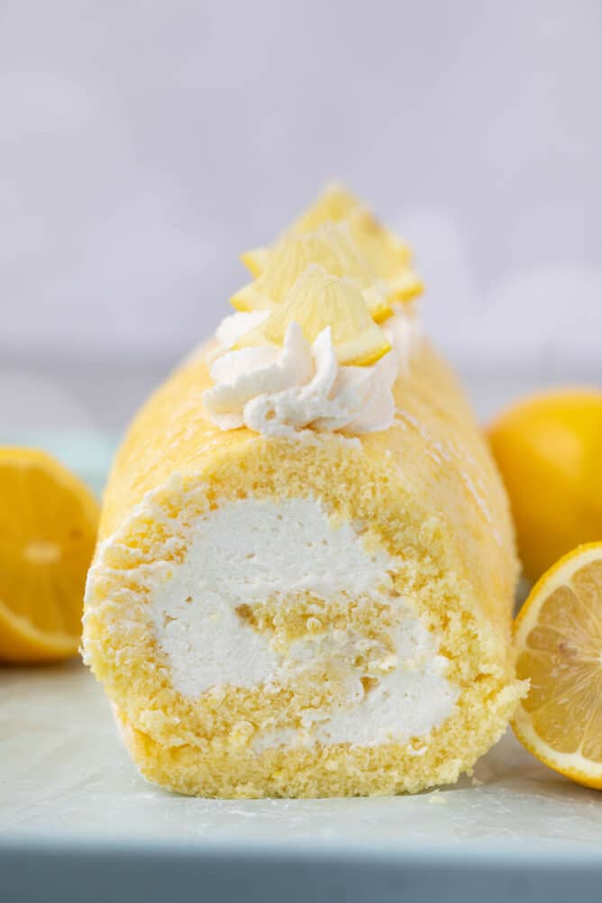 It's a lemon cake filled with lemon whipped cream. The perfect Lemon Cake Roll! front shot of sliced cake roll