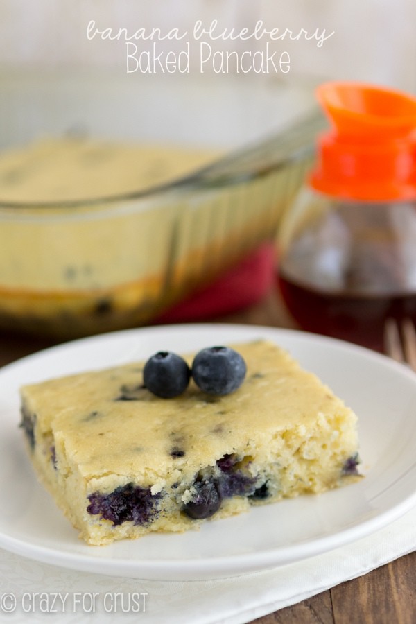 Blueberry Banana Baked Pancake on a white plate on a wooden board