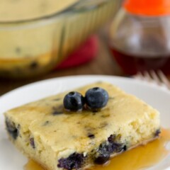 Blueberry Banana Baked Pancake on a white plate on a wooden board