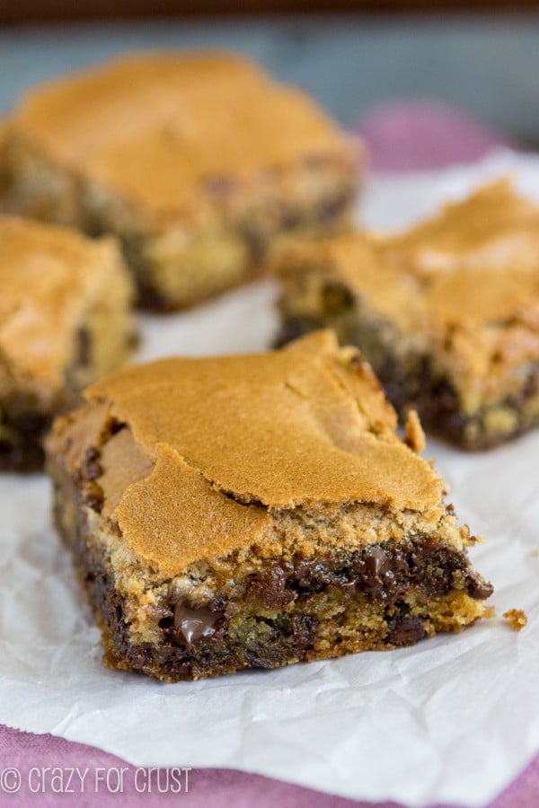 Chocolate Chip Cookie Mud Hen Bars - melty chocolate chip cookie topped with a brown sugar meringue sitting on parchment paper