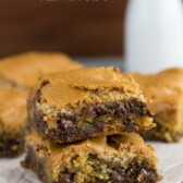 Chocolate Chip Cookie Mud Hen Bars Recipe - melty chocolate chip cookie topped with a brown sugar meringue sitting on parchment paper