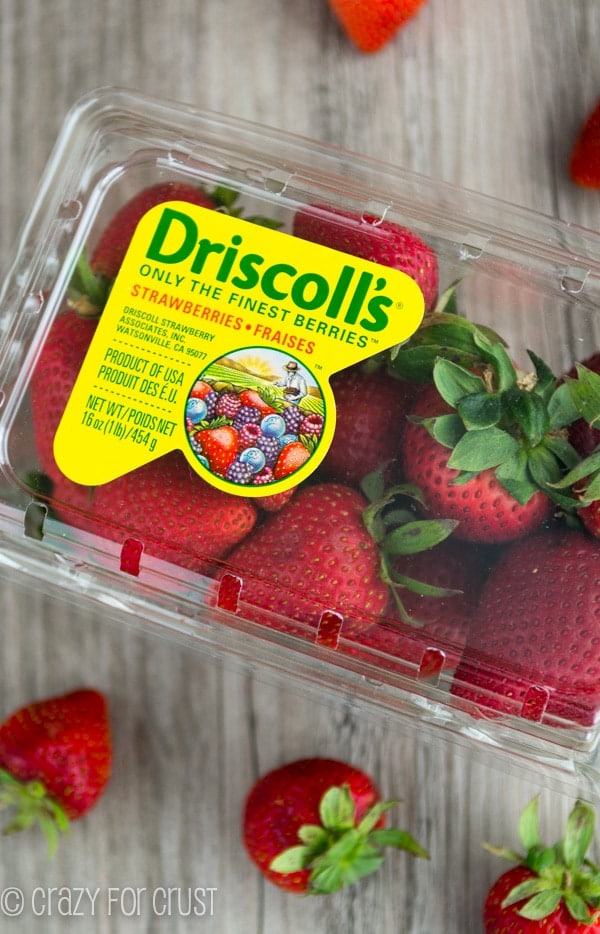 box of strawberries on a wooden board 