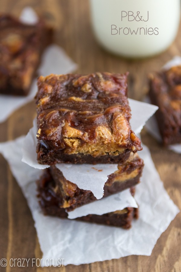 Peanut Butter and Jelly Brownies stacked on parchment paper 