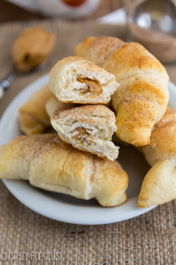 Peanut Butter Snickerdoodle Crescent Rolls split in half sitting on a white plate