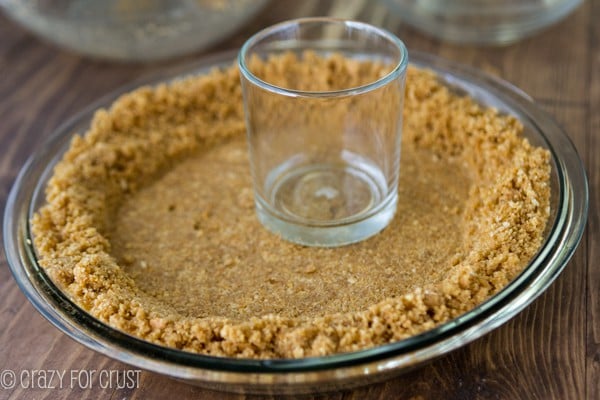 pressing the BEST Graham Cracker Crust into a pie pan
