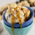 Caramel Corn Ice Cream in blue and green bowls with Carmel drizzle