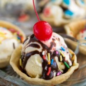 Ice cream pie in a clear bowl on a brown board