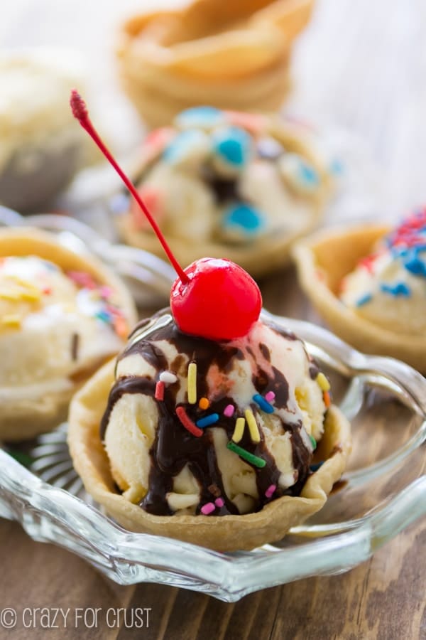 ice cream pie in a clear bowl with a cherry on top