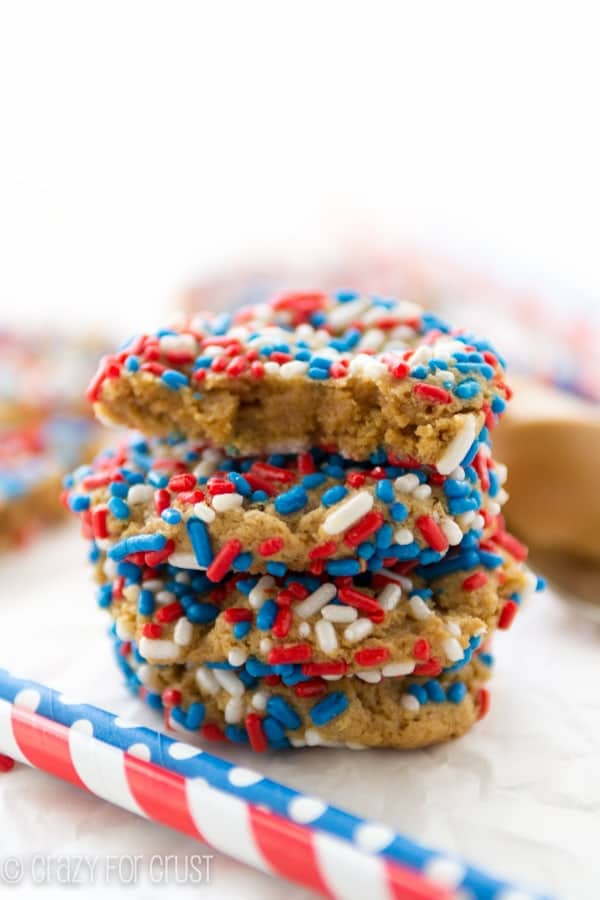 Peanut Butter Sprinkle Cookies with red, white and blue sprinkles and a bite taken out of one