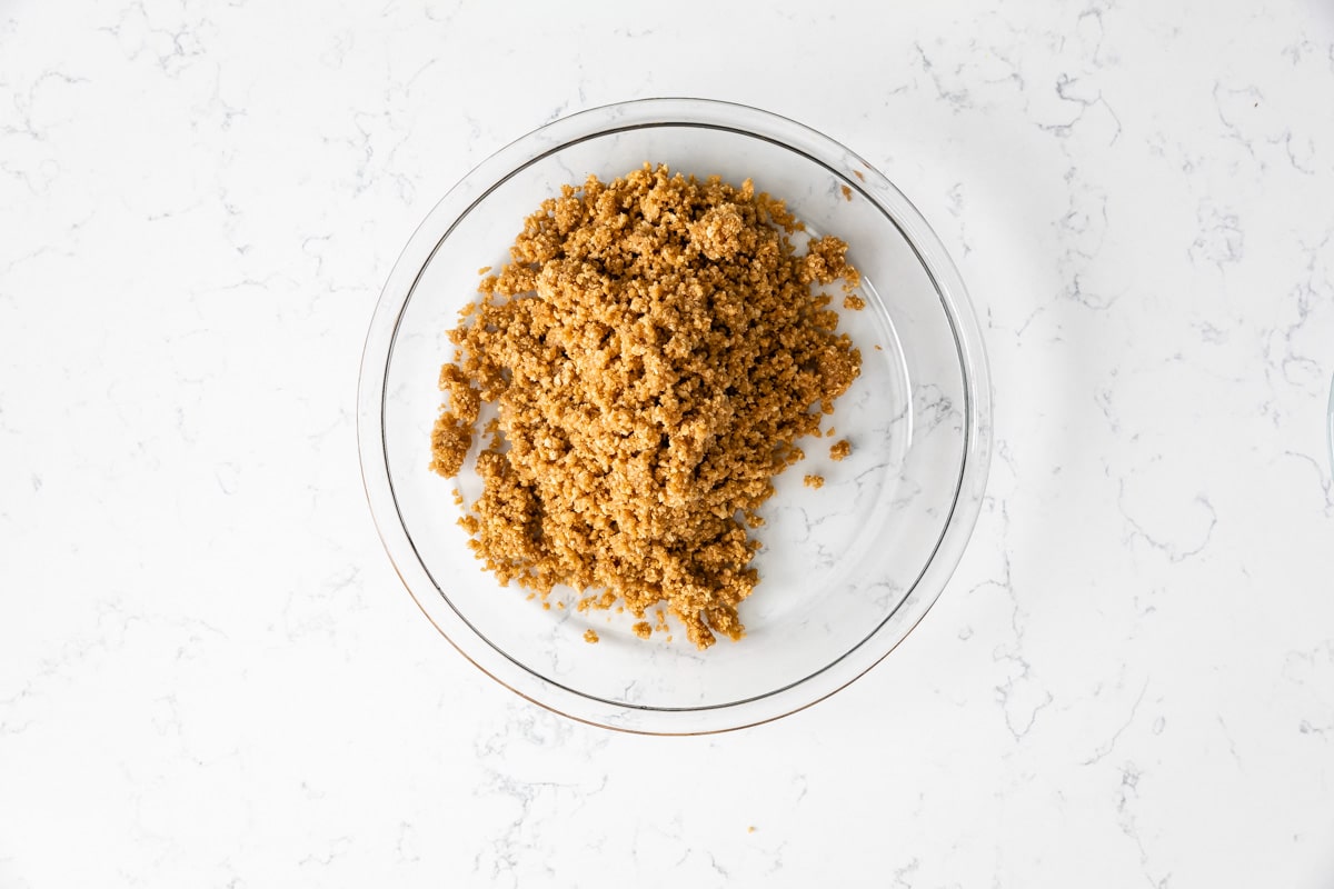 glass pie plate with graham cracker crust crumbs.