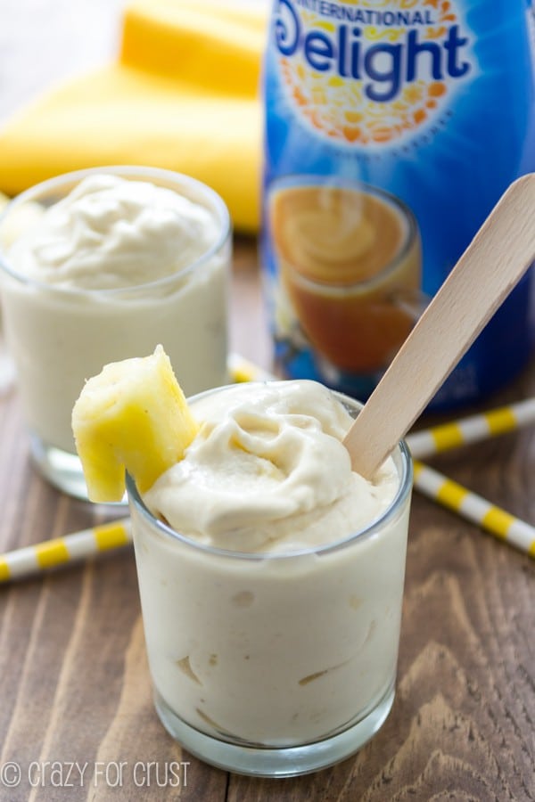 Copycat Pineapple Whip in clear short glass and International delight bottle in the background 