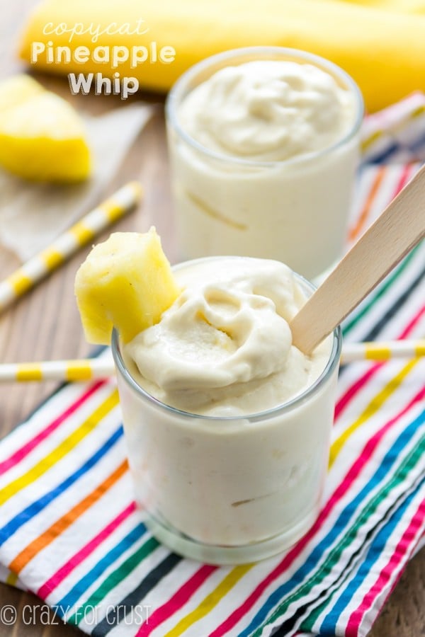 Copycat Pineapple Whip in a clear short glass with a pineapple on the side