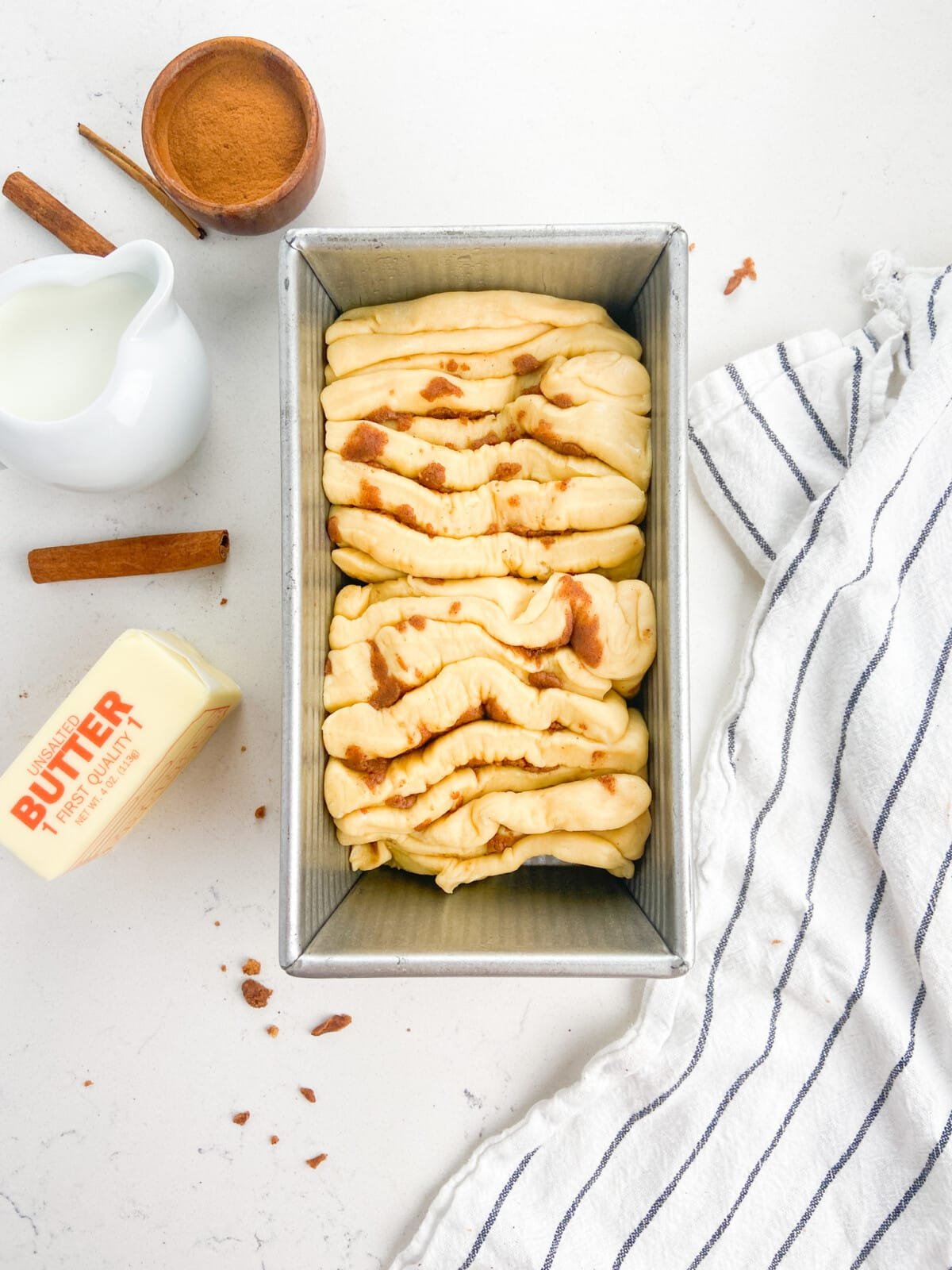 yeasted dough slices in bread pan.