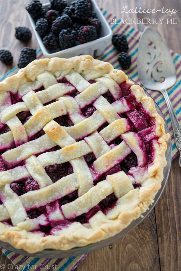 Blackberry Pie with a lattice top and a bowl of blackberries