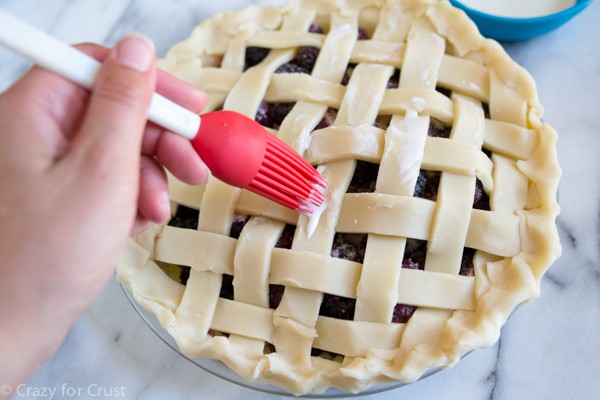 topping a lattice pie with cream