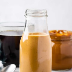 creamer in jar with coffee behind