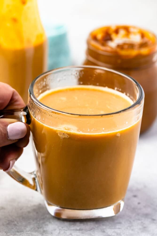 coffee in clear mug with creamer