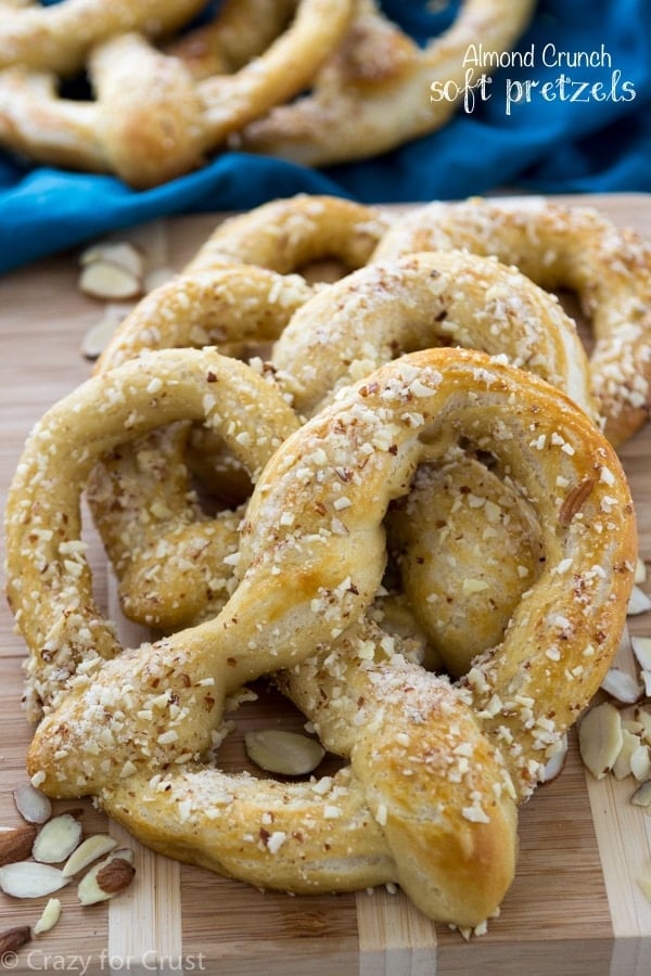 soft pretzel with almond topping on cookie sheet