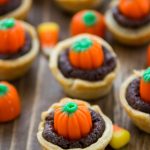 mini brownie pie with crust and candy pumpkin on top
