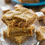 stack of peanut butter cookie bars with caramel in center