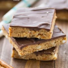 stack of peanut butter bars with pretzels and chocolate top