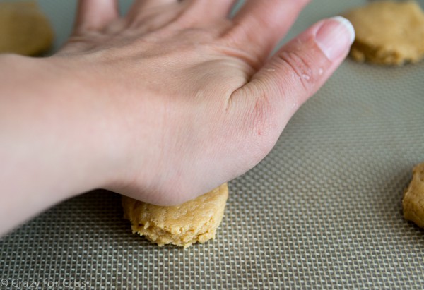 flattening peanut butter cookie dough with palm